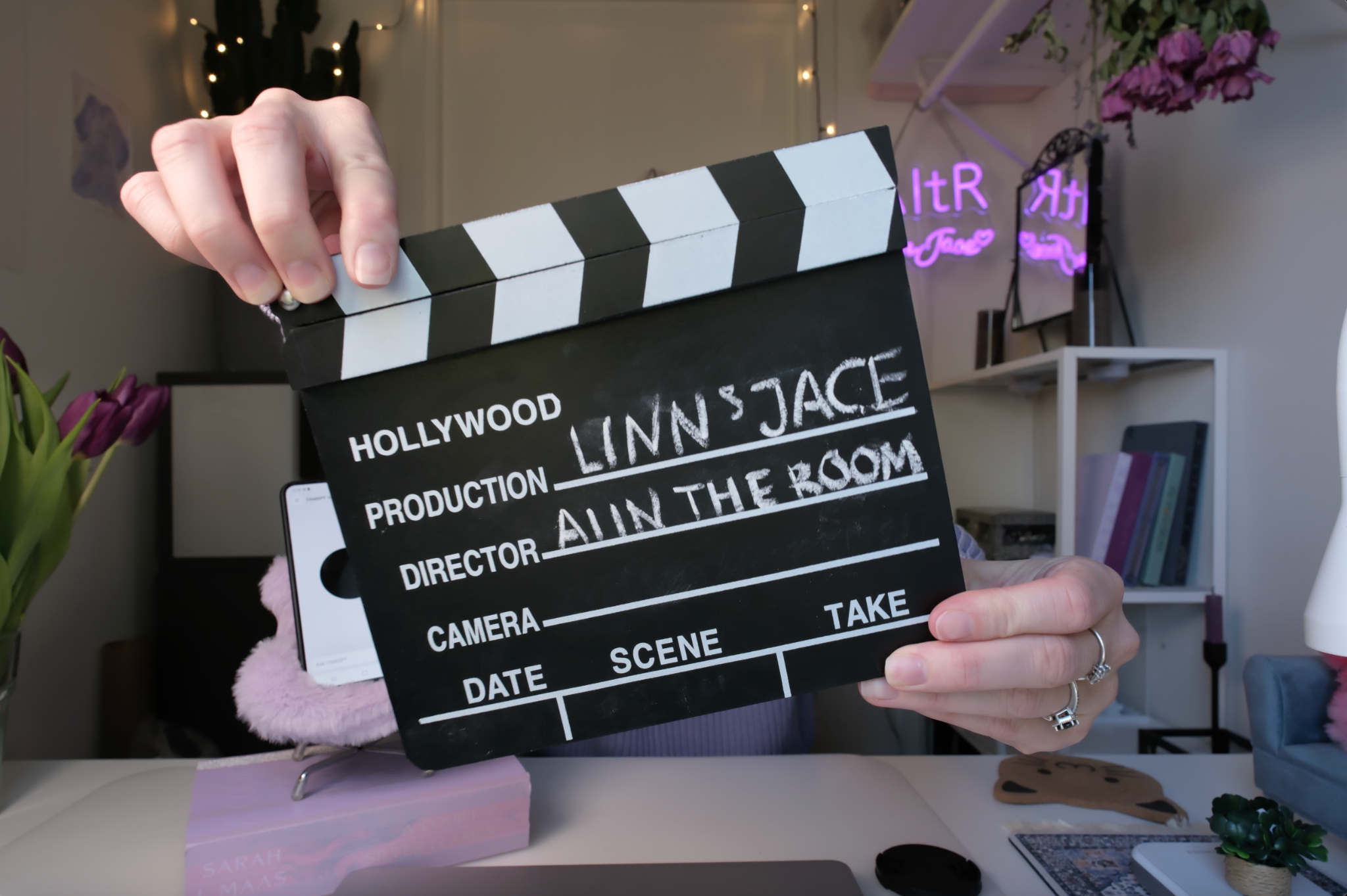 Linn holding a clapperboard marked Linn and Jace, AI in the Room